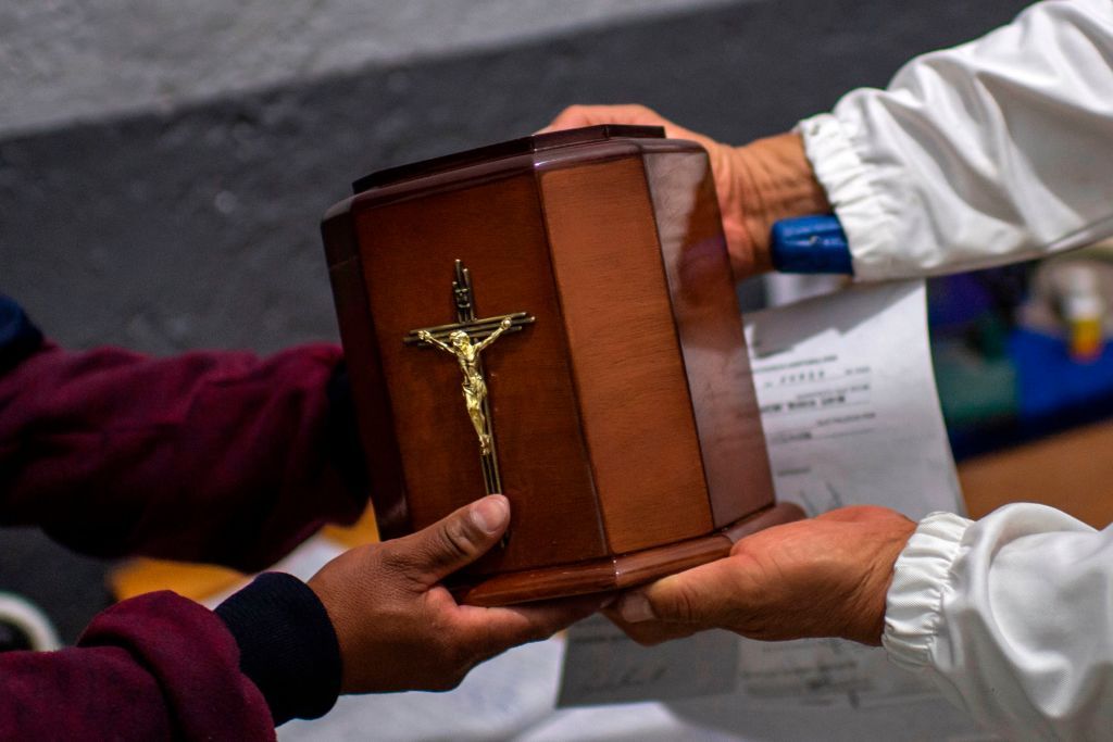 A man receives the urn containing his father&amp;#039;s ashes.