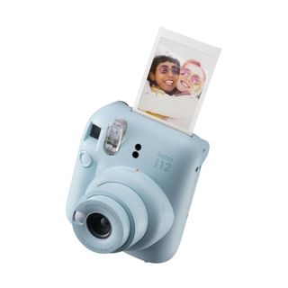 A blue instant camera with a picture coming out of it