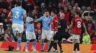 Antony and Jeremy Doku clash during the Manchester derby at Old Trafford in October 2023.