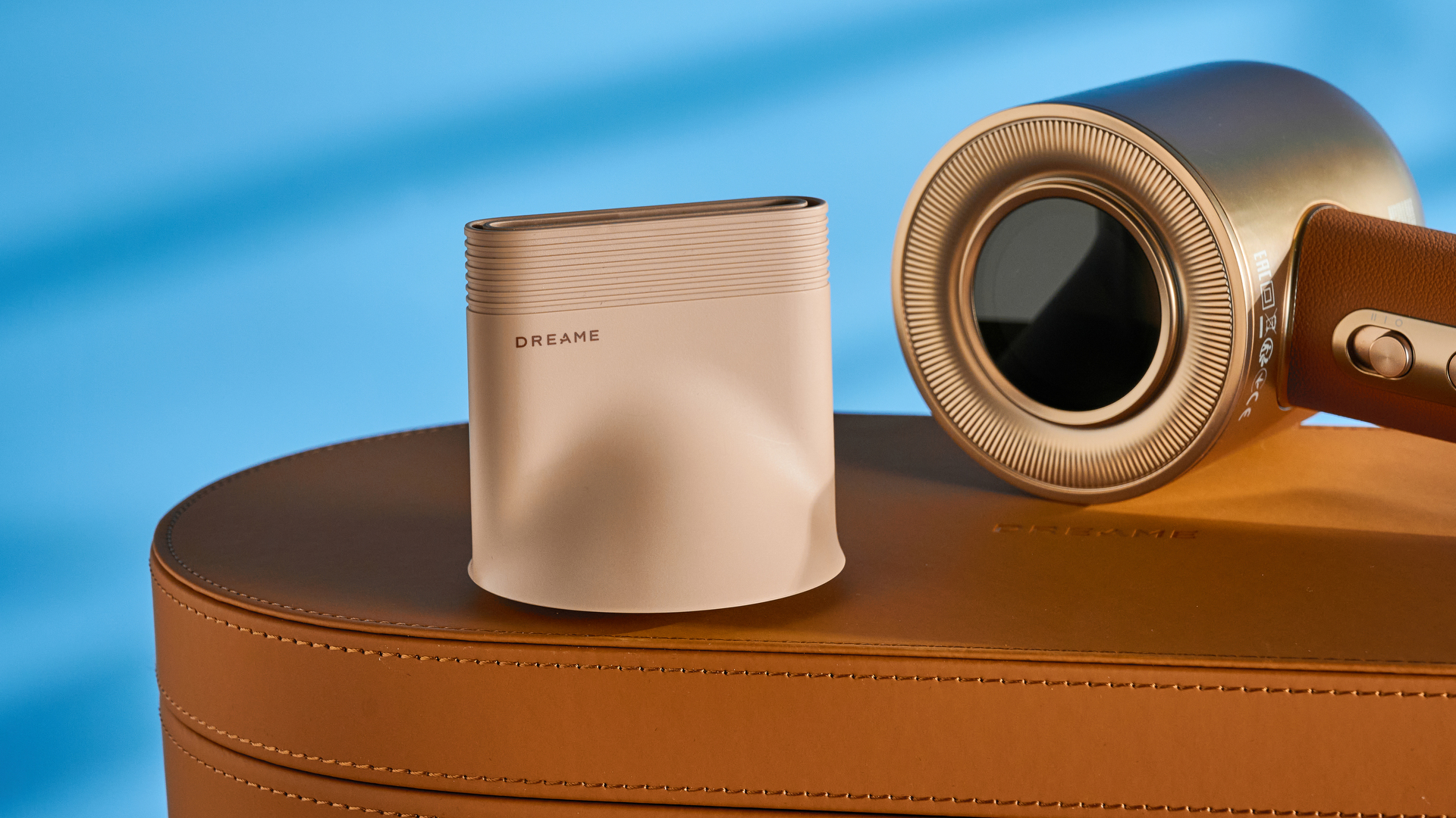 the dreame miracle pro hair dryer in gold showing the storage box on the blue tom's guide background, with the four attachment nozzles including two blow-drying nozzles, diffuser, and the flyaway tamer