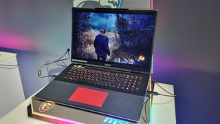 The MSI Titan 18 HX with its touchpad lit up in red, on a pedestal