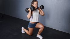 A woman performing a dumbbell lunge