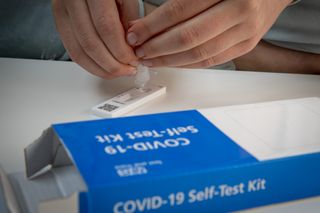 a student doing a lateral flow test in a secondary school