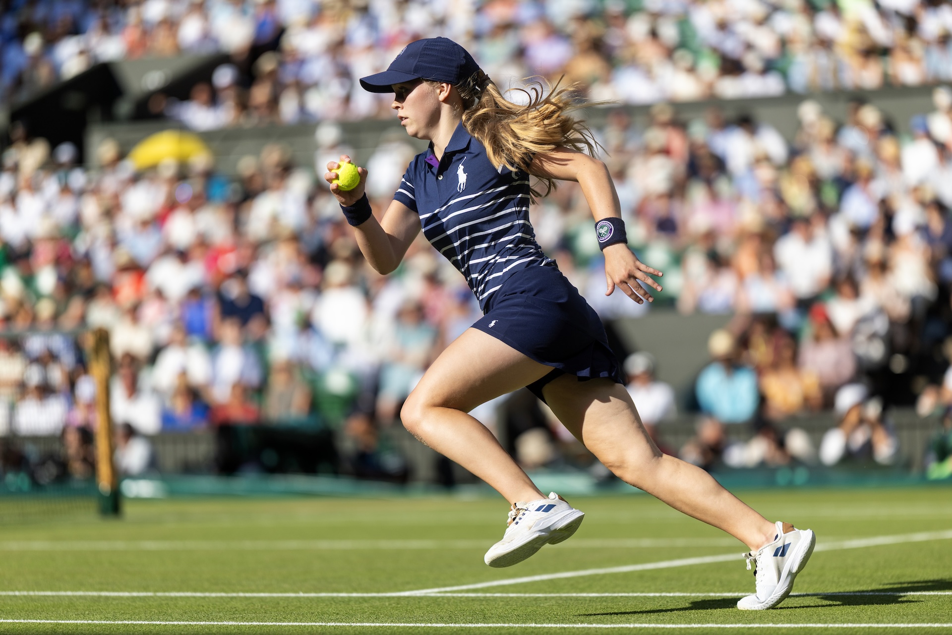 LONDON, ENGLAND - JULY 13: A ball girl retrieves the ball during the Gentlemen's Singles Final on Centre Court during the Wimbledon Lawn Tennis Championships at the All England Lawn Tennis and Croquet Club at Wimbledon on July 13th, 2025, in London, England. (Photo by Tim Clayton/Getty Images)