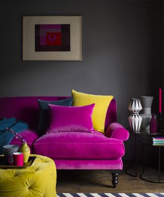 Pink velvet sofa in dark grey living room