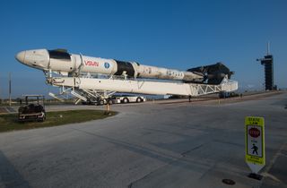 Rolling down the road is a SpaceX Falcon 9 rocket with the company's Crew Dragon spacecraft attached in preparation for the launch of the Crew-2 mission. Crew-2 is expected to launch from NASA's Kennedy Space Center in Florida from Pad 39A on Thursday April 22.