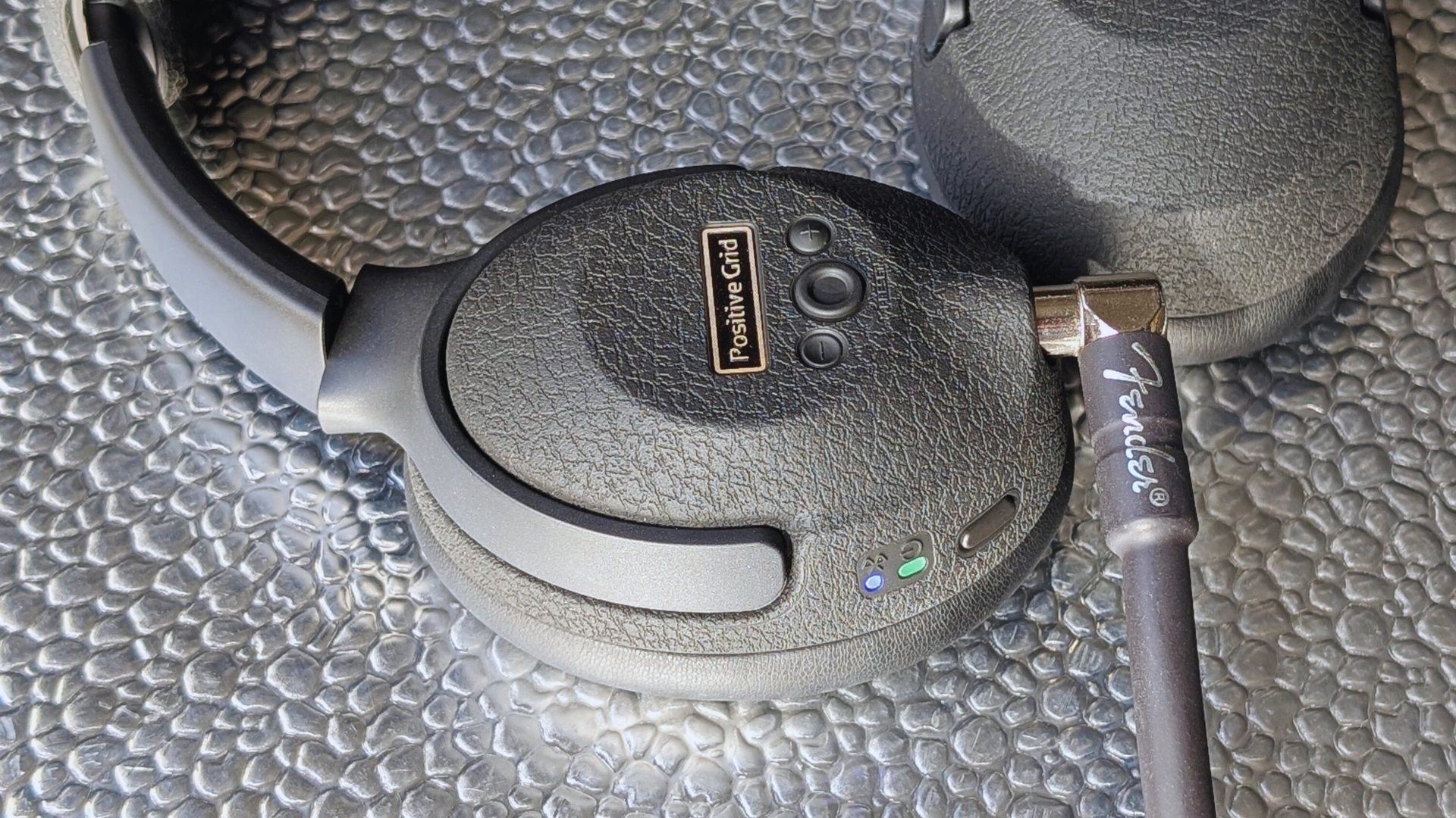 Close up of the buttons on a pair of Positive Grid Spark Neo Core headphones
