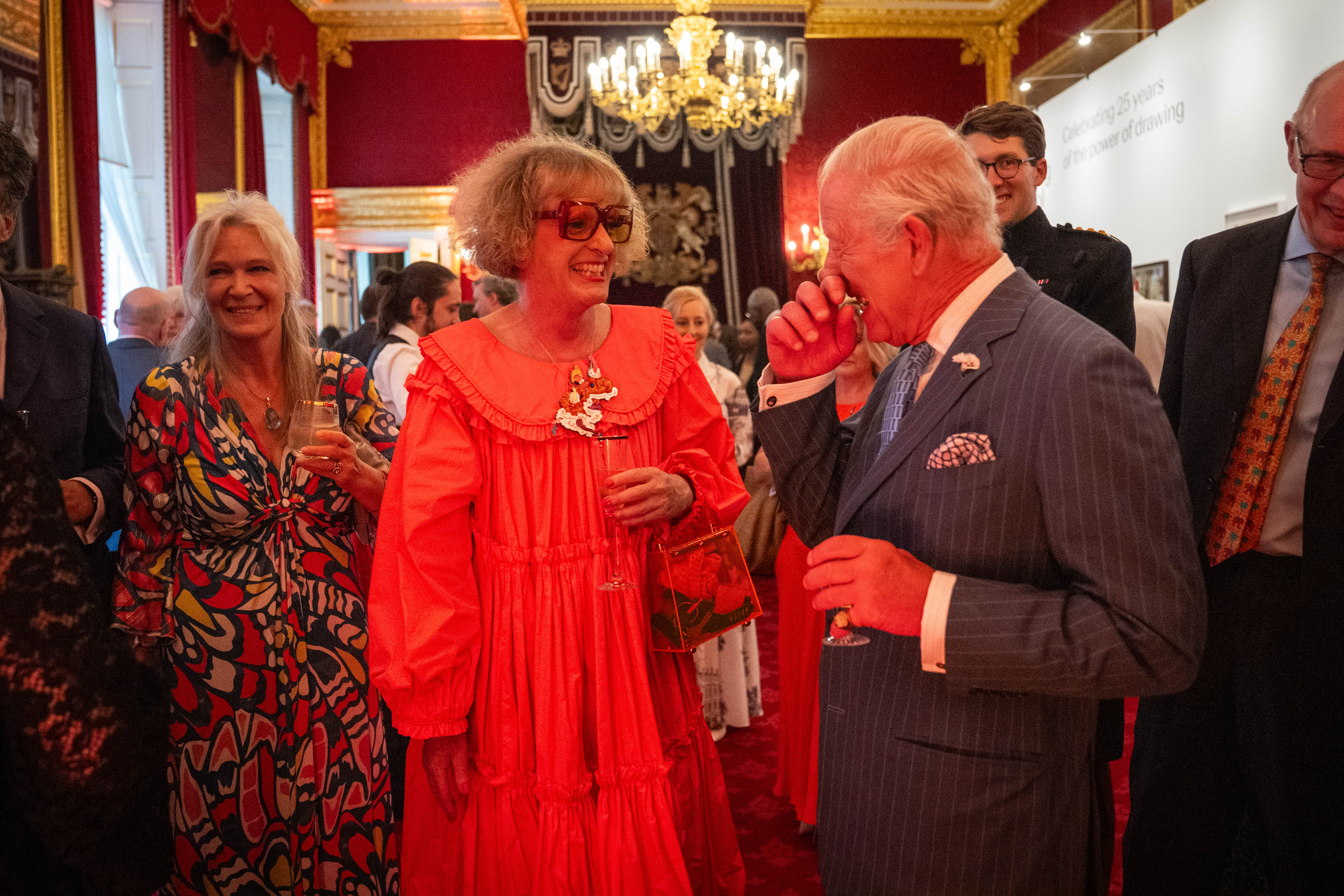 Grayson Perry and King Charles laughing at a reception