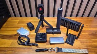 Chargers, cables, webcam, screwdriver, Wi-Fi adapter and USB hub on a bench