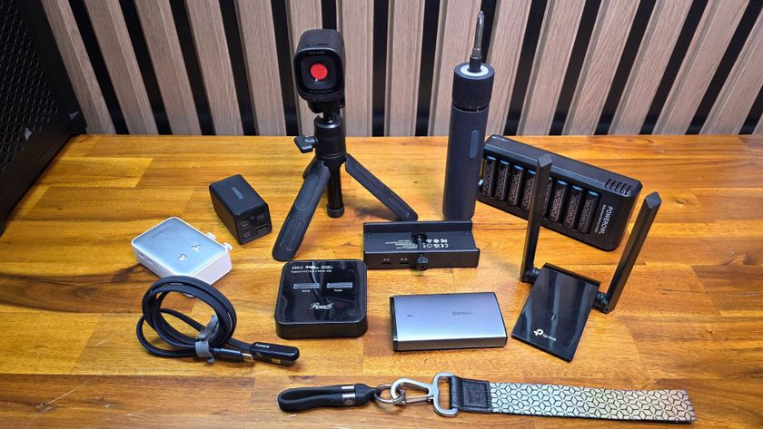 Chargers, cables, webcam, screwdriver, Wi-Fi adapter and USB hub on a bench