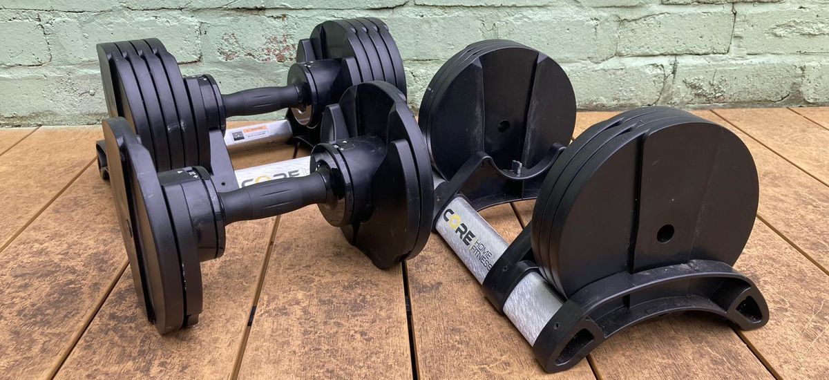 Core Home Fitness Adjustable Dumbbells next to cradle