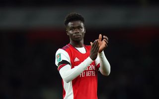 Arsenal midfielder Bukayo Saka applauding