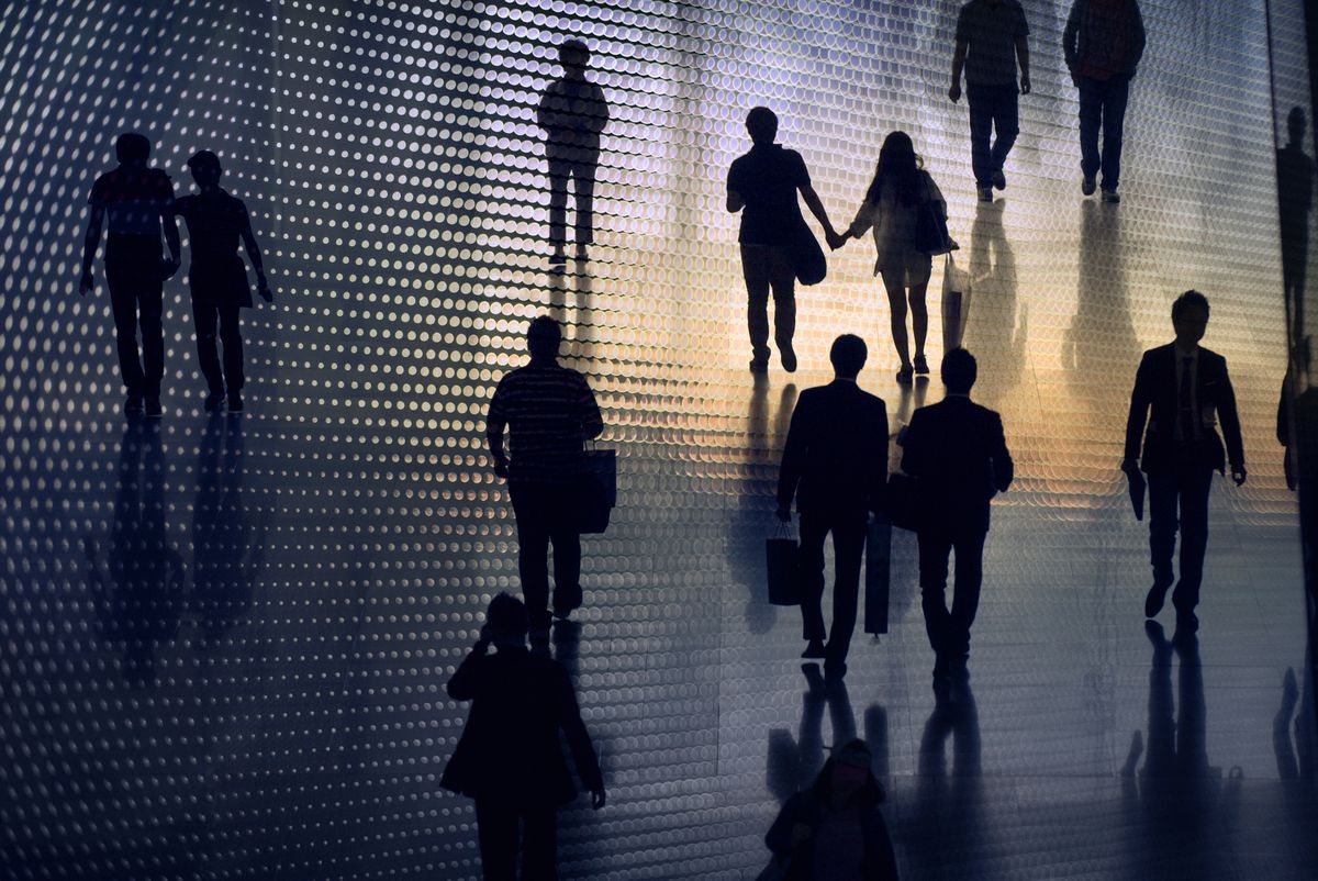 Multiple exposure image of people walking in city 