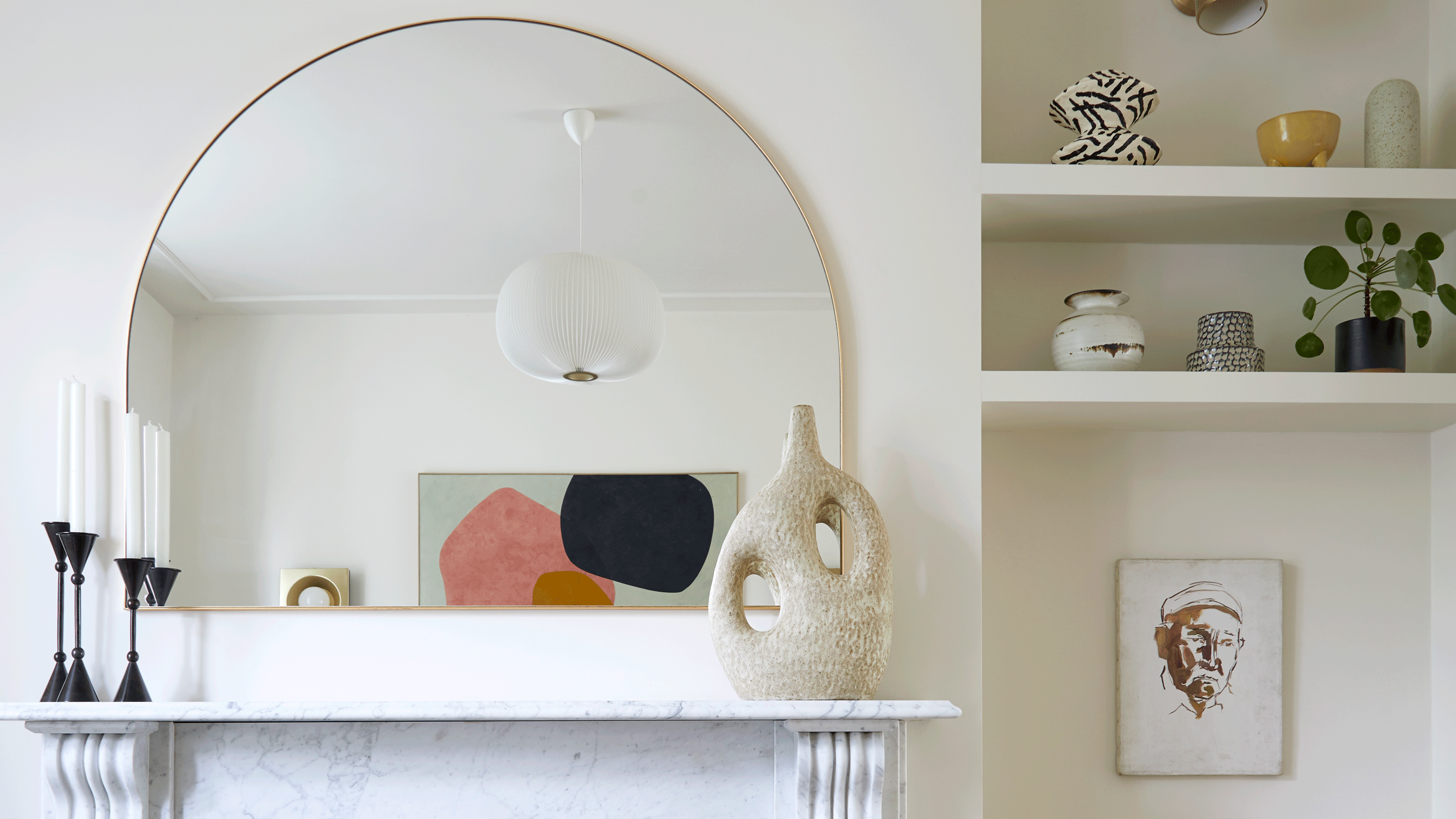 White living room with large mirror and shelves