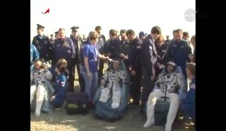 Expedition 39 astronauts Koichi Wakata, Mikhail Tyurin and Rick Mastracchio (left to right) rest after landing in a Soyuz capsule on May 13, 2014.