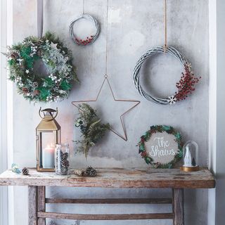Christmas wreath and star hanging above rustic bench