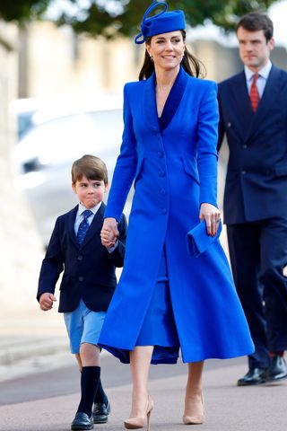 Prince Louis of Wales and Catherine, Princess of Wales - who carries a blue clutch bag - attend the traditional Easter Sunday Mattins Service at St George's Chapel, Windsor Castle on April 9, 2023 in Windsor, England.