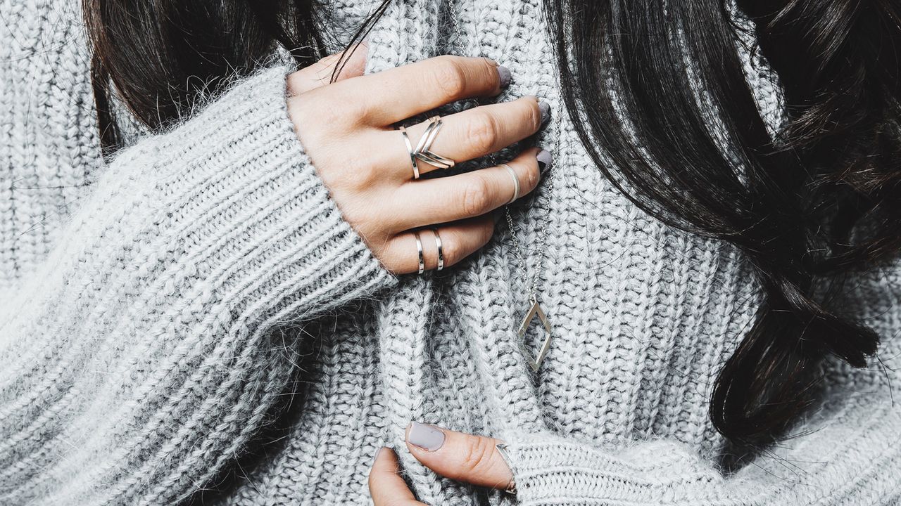 Close up of woman&#039;s hands with rings on