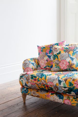 close up of yellow floral vibrant patterned sofa
