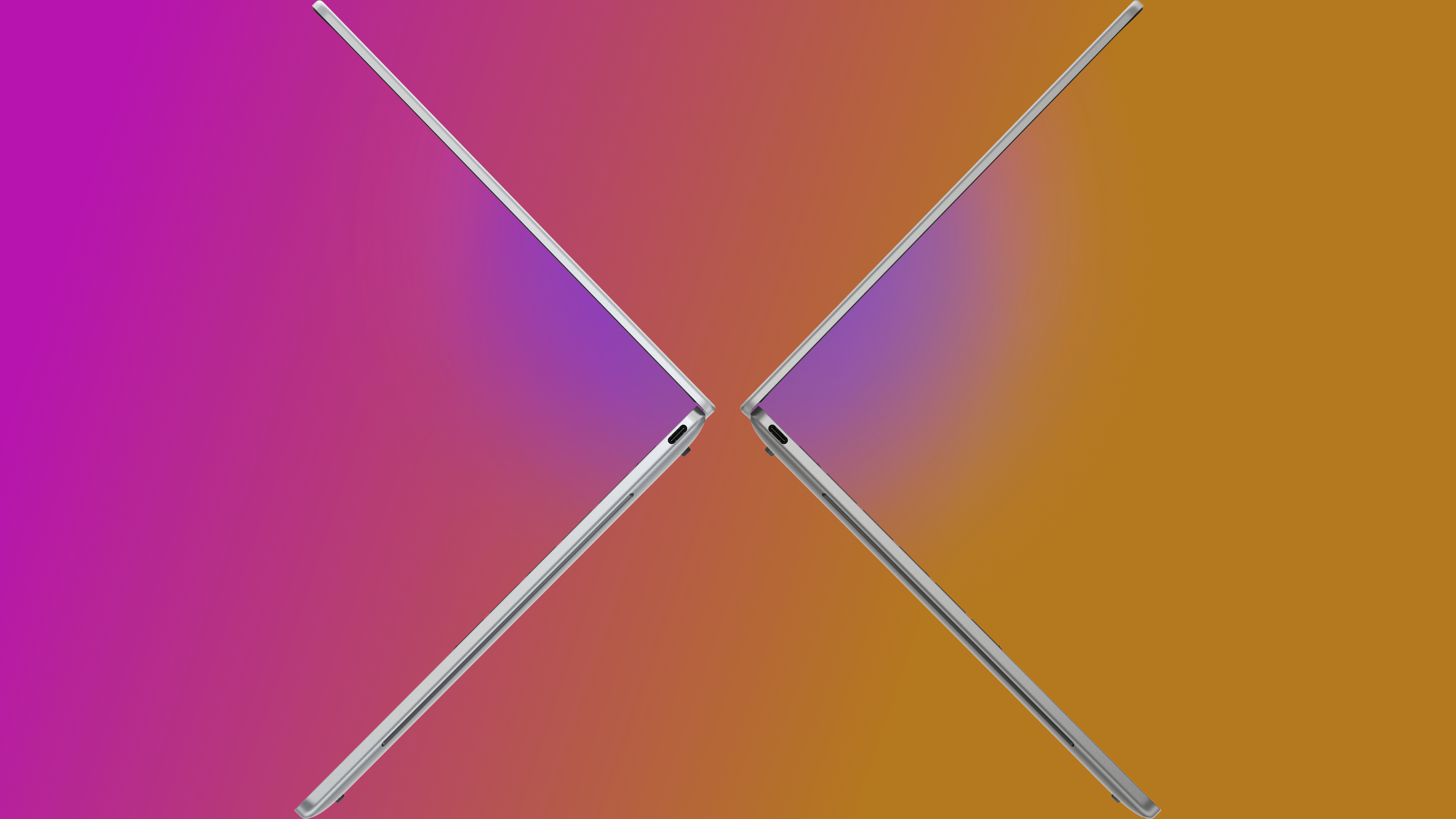 Two silver XPS 13 laptops open and facing each other against a pink to orange gradient background.