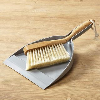 wooden flooring with dustpan and hand brush