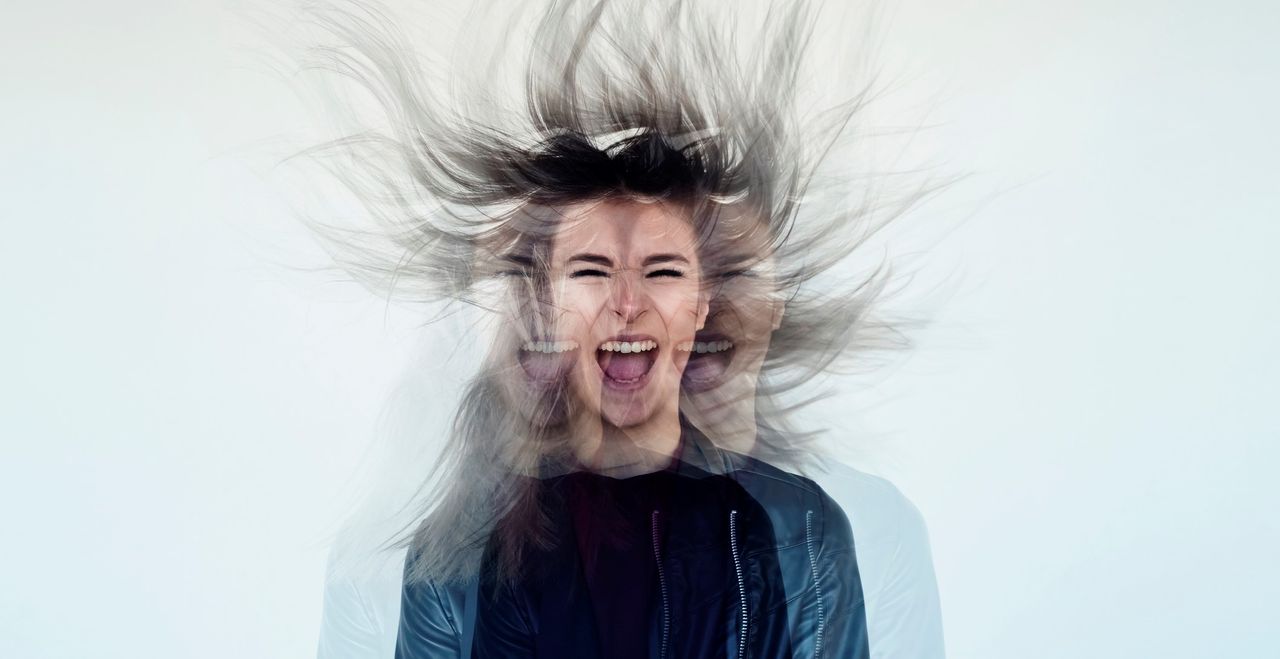 Digital manipulation of a young woman&#039;s image tossing her flowing gray long hair