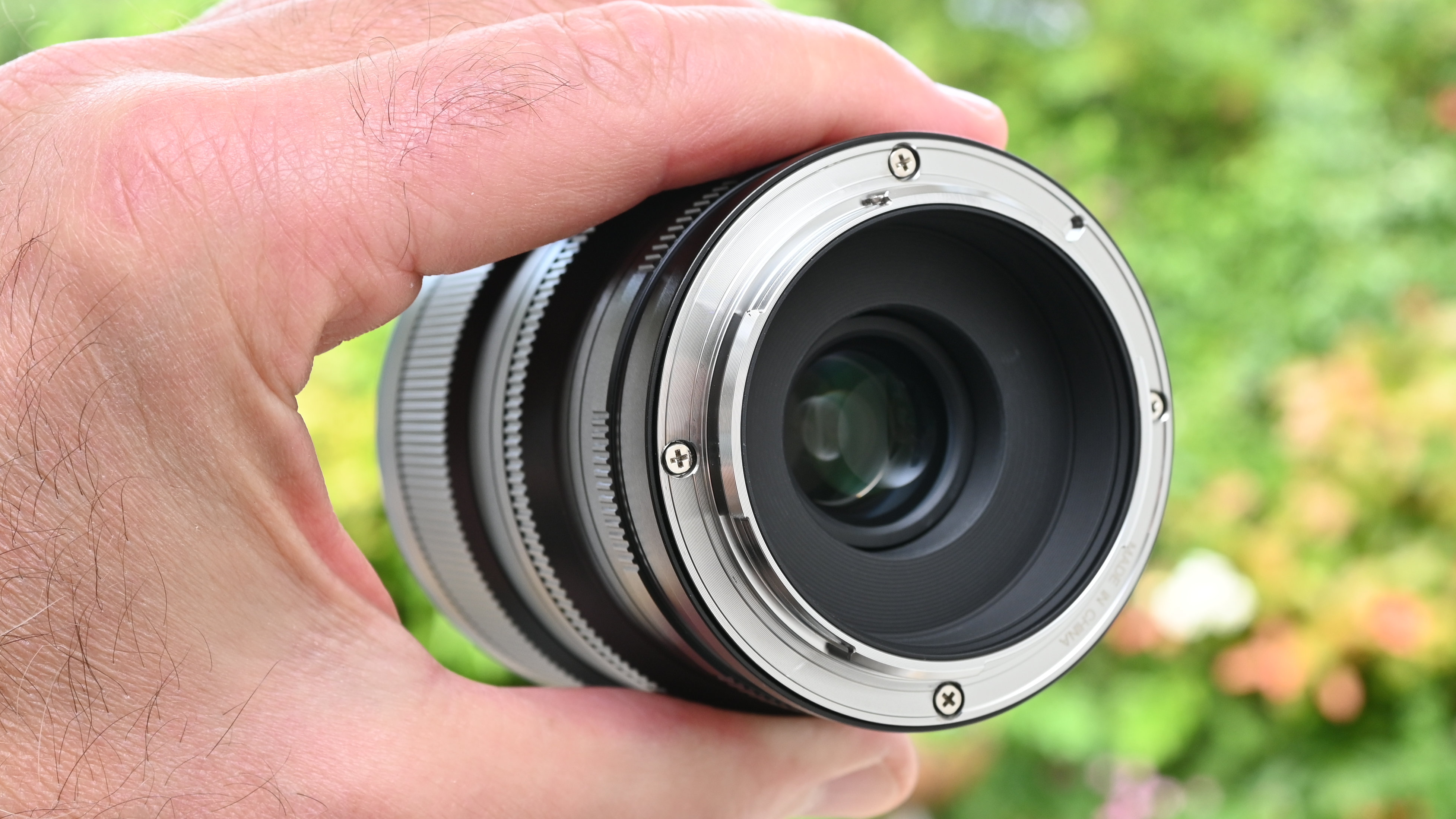 Laowa 8-15mm f/2.8 FF Zoom Fisheye product image of lens held in hand