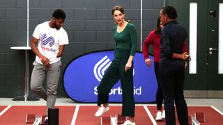 Catherine, Duchess of Cambridge prepares to race against para-athlete sprinter Emmanuel Oyinbo-Coker (L) and heptathlete Jessica Ennis-Hill (R hidden) during a SportsAid Stars event at the London Stadium in Stratford on February 26, 2020 in London,