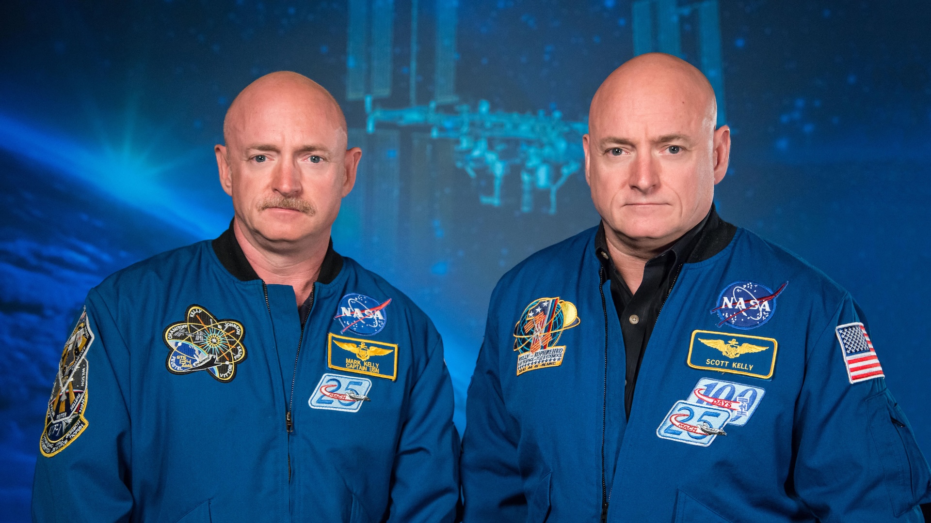 Astronauts Scott and Mark Kelly in NASA jackets