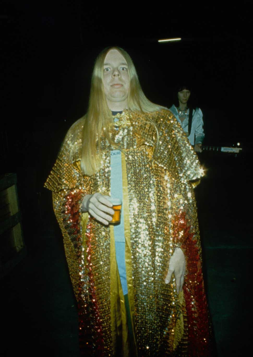 Rick Wearing wearing a cape holding a glass of beer