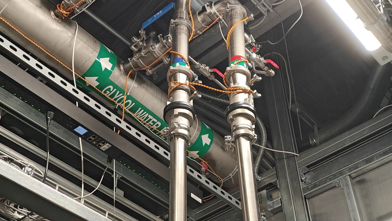 Two pipes of liquid cooling going to an NVL72 tray