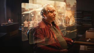 A man with his eyes closed and a device on his forehead sits in a chair, with translucent images of people and a street scene superimposed in front of him.