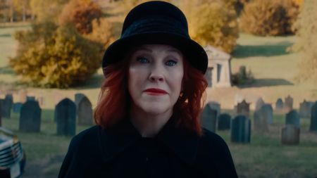Catherine O'Hara as Delia Deetz standing in a graveyard in Beetlejuice Beetlejuice.