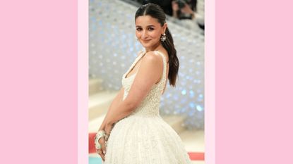 Alia Bhatt wears a white, pearl gown as she attends The 2023 Met Gala Celebrating "Karl Lagerfeld: A Line Of Beauty" at The Metropolitan Museum of Art on May 01, 2023 in New York City. / in a pink template