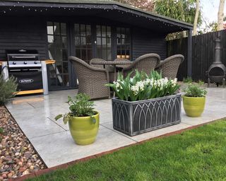 BBQ on patio with shed and planter