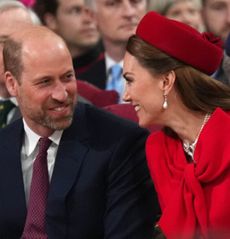 Kate Middleton and Prince William laughing and turning to smile at each other 