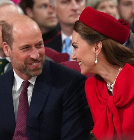 Kate Middleton and Prince William laughing and turning to smile at each other 