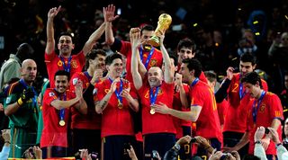 Spain players celebrate with the World Cup trophy after their win over the Netherlands in July 2010.