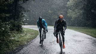 Two riders in shakedry jackets riding in the rain