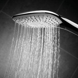 bathroom with grey tiled walls and shower