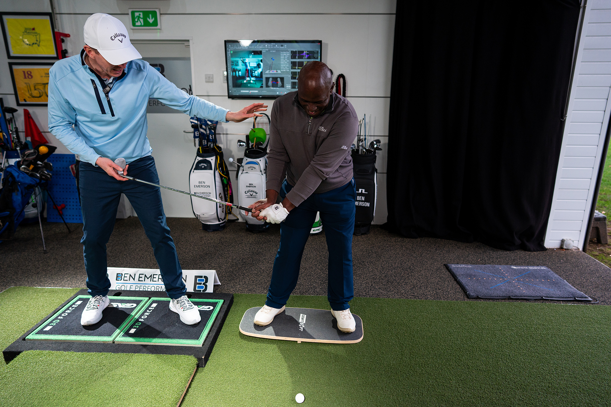 Ben Emerson in the game changer clinic helping an amateur golfer by demonstrating the importance of weight distribution for short game shots