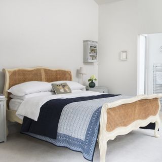 White bedroom with French cane and white wood bed