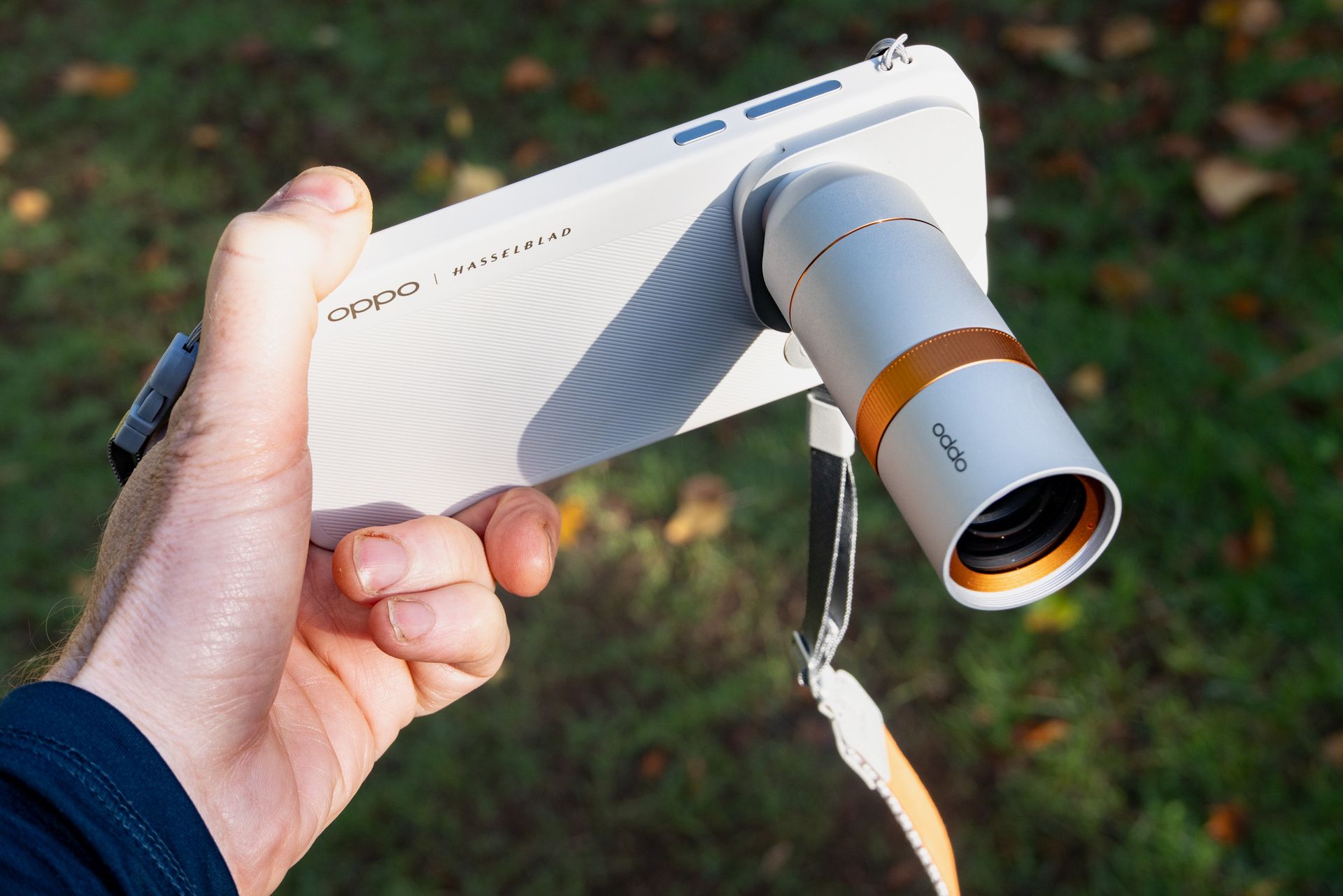 Oppo Find X10 Pro Max phone in user's hand, with 300mm teleconverter lens attached