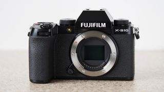 Fujifilm X-S10 best travel camera sitting on a marble table