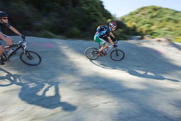 Riders take a berm at high speed.