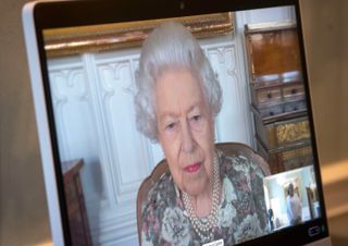 LONDON, ENGLAND - JUNE 08: Queen Elizabeth II appears on a screen via videolink from Windsor Castle, where she is in residence, during a virtual audience to receive the Ambassador from the Republic of South Sudan, Agnes Oswaha, at Buckingham Palace on June 8, 2021 in London, England. (Photo Victoria Jones - by Pool/Getty Images)