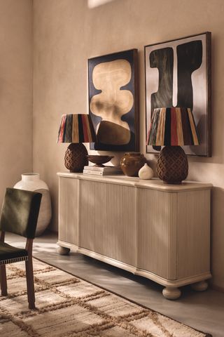 matching table lamps on a sideboard with chairs and a table