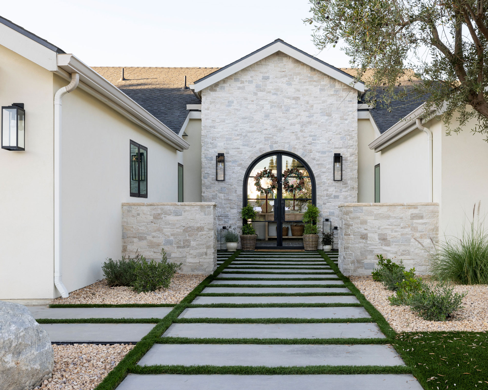 modern garden design with gravel and planting, a pathway edged with grass, large tree and ornamental grasses