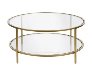 A gold finish glass coffee table with bottom shelf