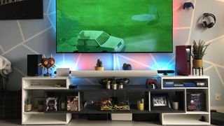 A TV setup with screen, games consoles, soundbar and set-top boxes, and no visible cables